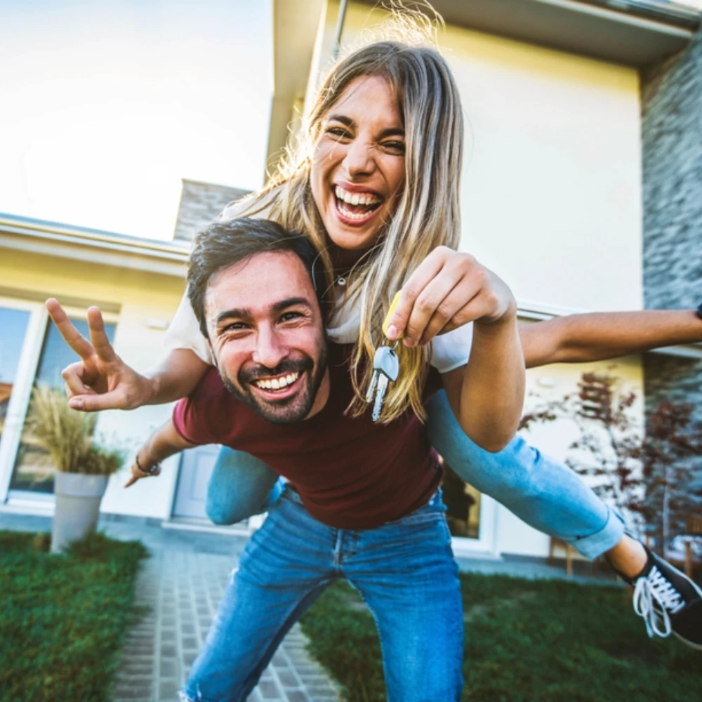 Happy,Young,Couple,Holding,Home,Keys,After,Buying,Real,Estate